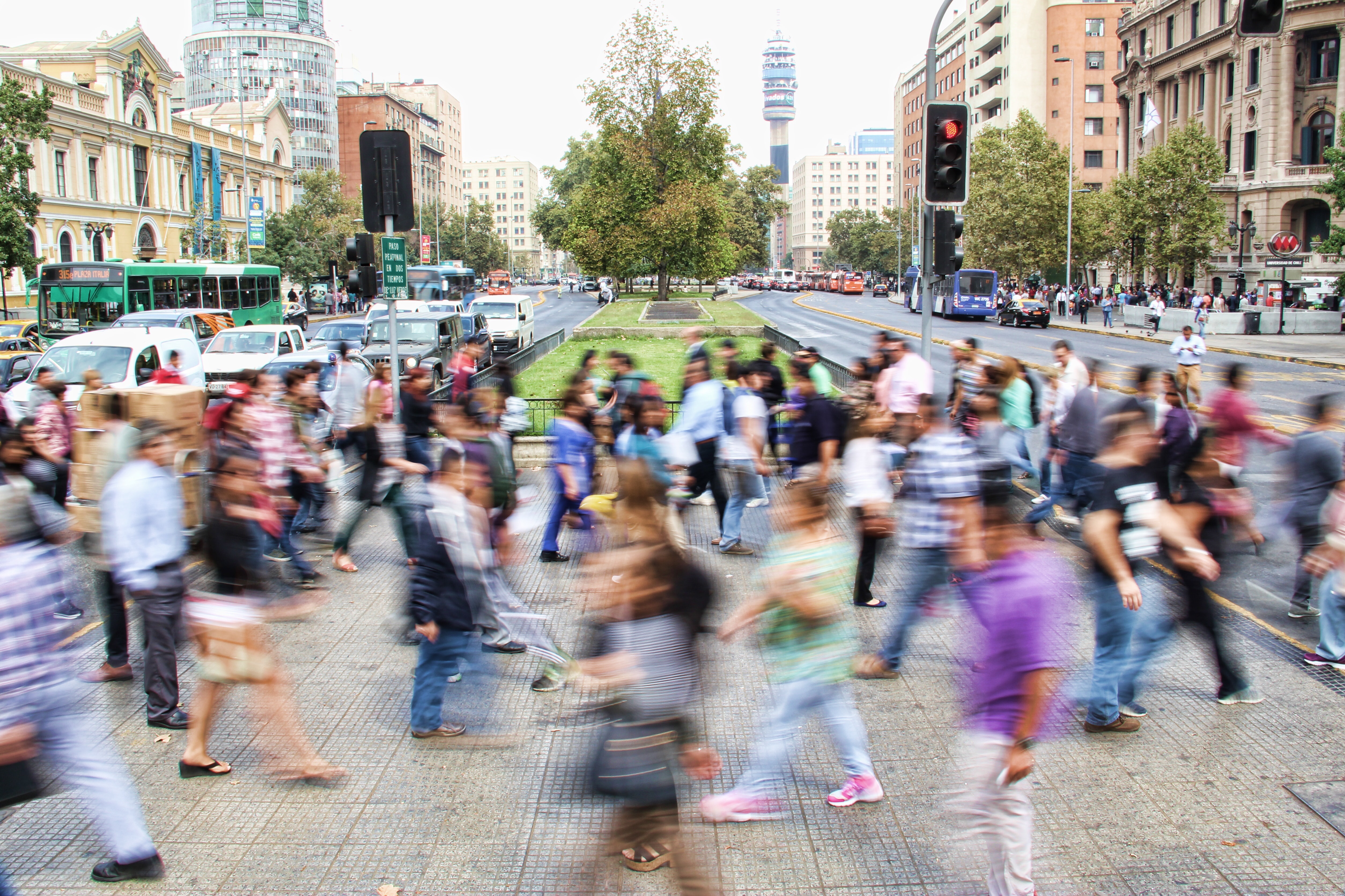 a blur of people rushing across a busy, city street